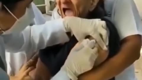 The old women is screaming while taking the vaccine