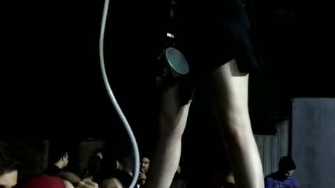 Girl blue shirt standing on guys and drinking beer