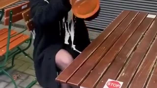 The girl "drinks" a huge glass of beer