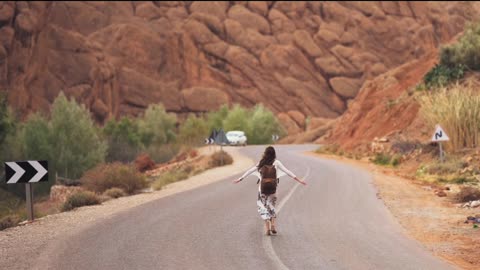 A girl walking on a road in a sunny day