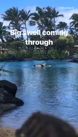 Big swell coming through guy surfs onto lake