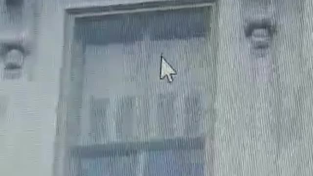Antifa hangs flag in the Capital building window.
