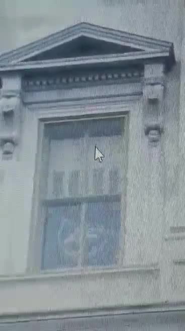 Antifa hangs flag in the Capital building window.