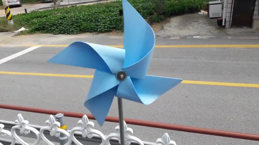 A pinwheel is turning by the wind