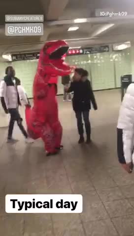 Red trex dinosaur walking through subway station
