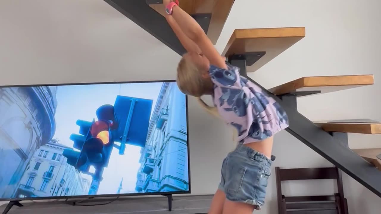 Acrobatic Girl Monkey Bars Backward Up Underside Of Staircase