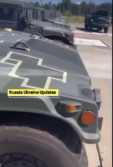 Ukrainian servicemen apply camouflage to vehicles transferred by the American army