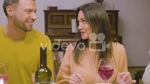 Husband And Wife Talking During A Family Dinner Sitting At Table At Home