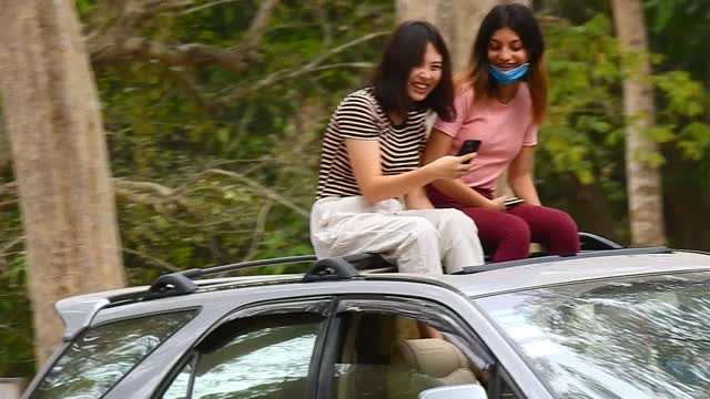 Beautiful lady came to visit the monkey seem really funny on her own car.