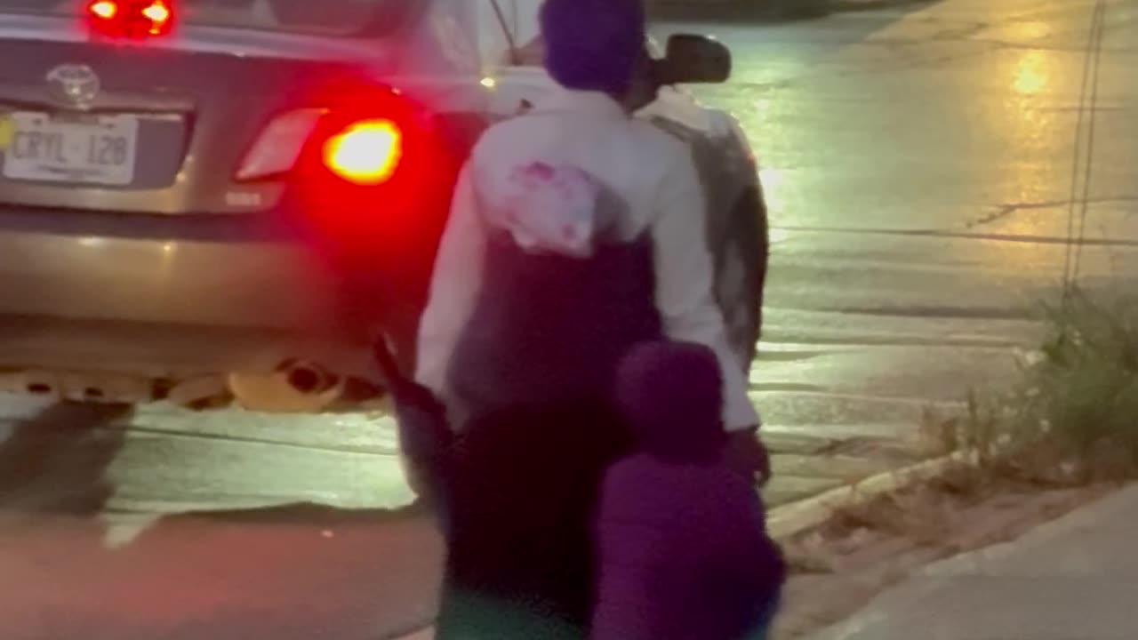 Woman Balances Microwave On Head During Walk