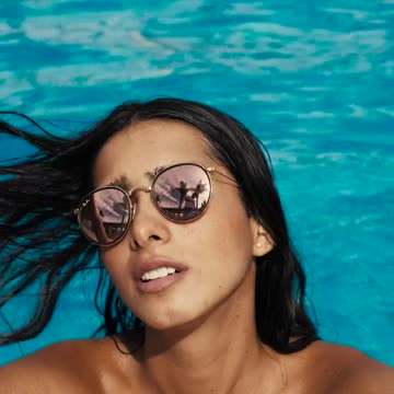 Woman face by the swimming pool