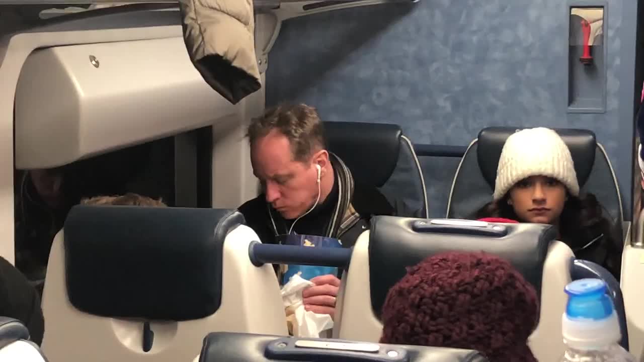 Guy not using hands to eat popcorn out of bag