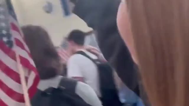 Washington Student Protesting the Mask Mandates carrying The American Flag