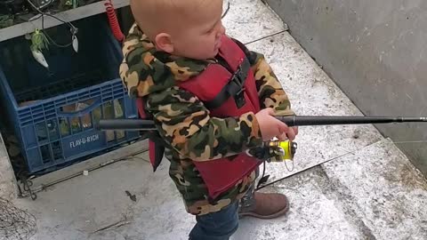 Son fishing with dad. Little boy fishing with dad.