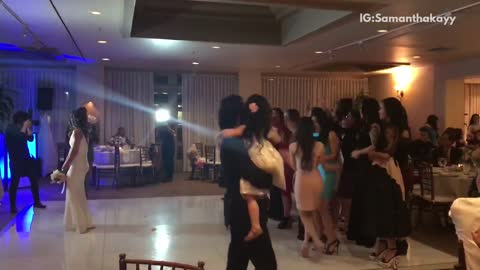 Woman in red dress catches bouquet boyfriend nervous