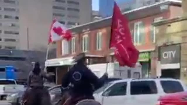 OTTAWA: A man on horseback waves a 'TRUMP 2024' flag as he rides past truckers and protesters at