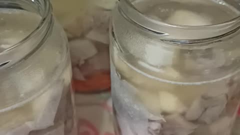 Pouring gelatine in to jars with meat and boiled carrot