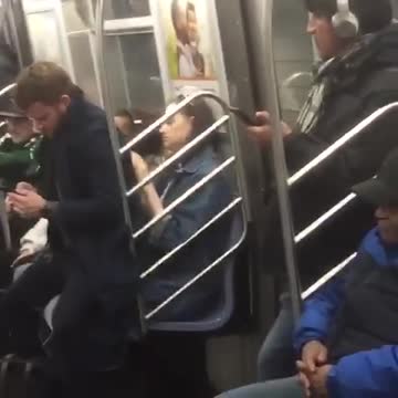 Man sits on girls lap on subway car