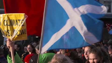 Handheld Shot of Scottish Flag Flying During Climate Change Protests In Glasgow