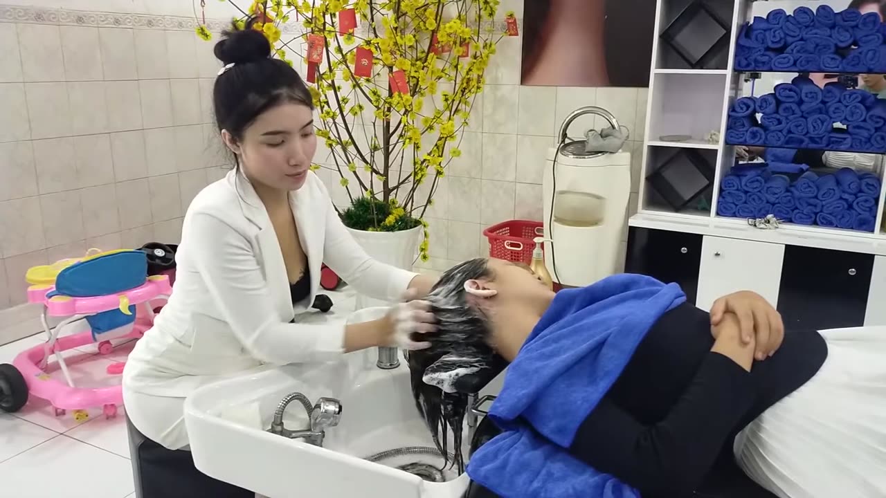 Relaxing service for women, shampoo and facial massage at Vietnamese barbershop with beautiful girl