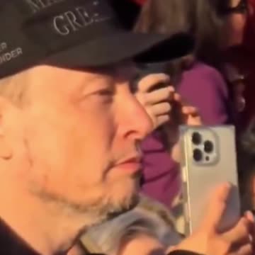 Elon Musk puts on a dark MAGA hat in front of a crowd at Trump’s rally in Butler