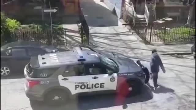 Toronto Police officer chased around car by a guy throwing stuff at her last summer