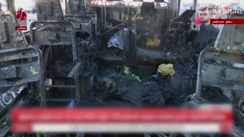 Charred smoking bus in Damascus bomb attack aftermath that killed 14