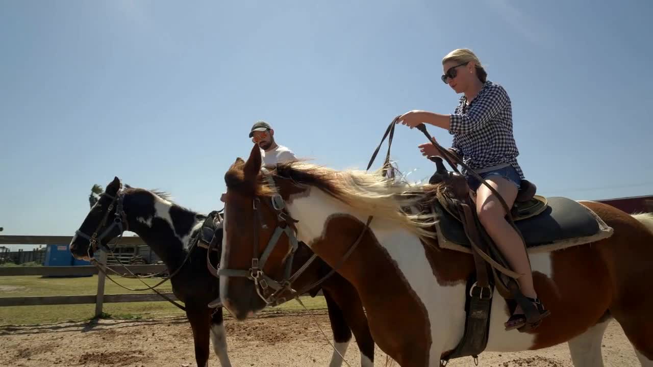 Couple Rides Horses on Texas Ranch