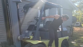 FORKLIFT UNLOADS AIR COMPRESSOR