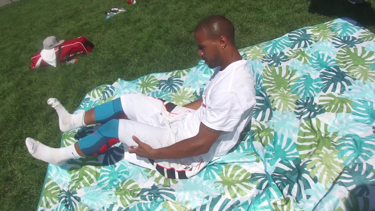 Luodong Massages Baseball Player In White Clothing At The Park