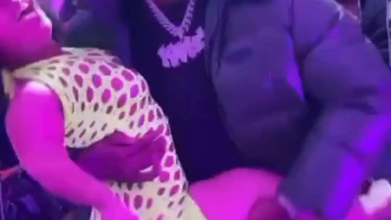 Rob49 out here going crazy in the club with a little person