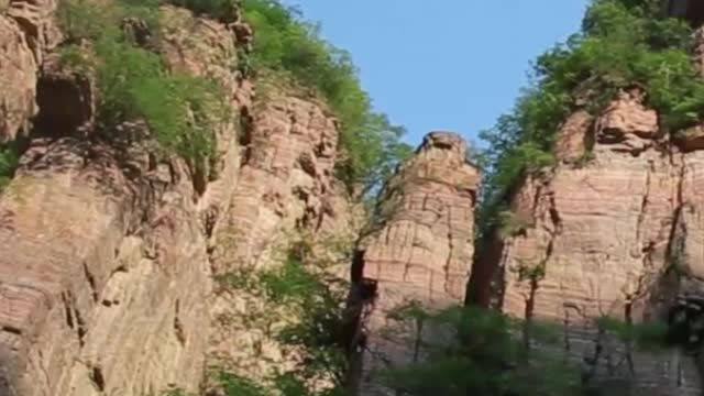 Green trees and high mountains form a beautiful landscape