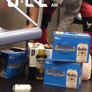 Man packing up three beer packs in subway