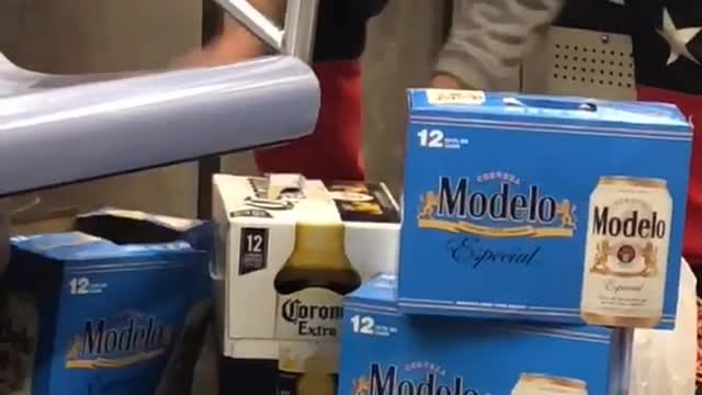 Man packing up three beer packs in subway