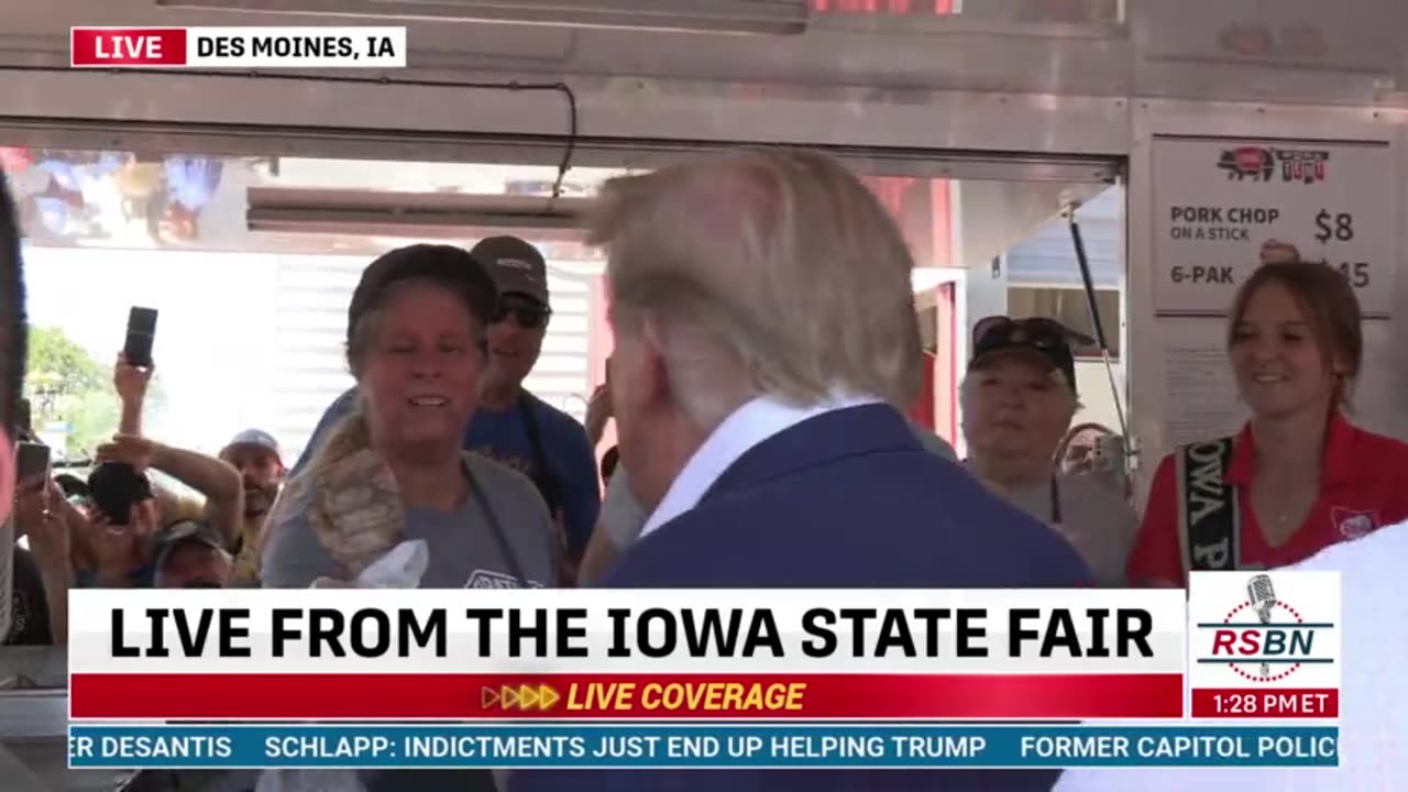 Brian Glenn receives a pork chop from President Donald J Trump at the Iowa State Fair