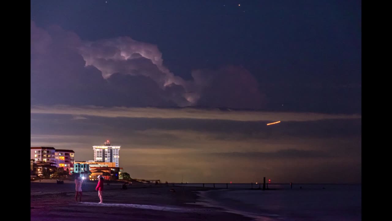 Beach Romance with Background Lightning