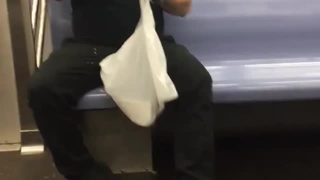 Man eating tacos on subway diner black polo shirt