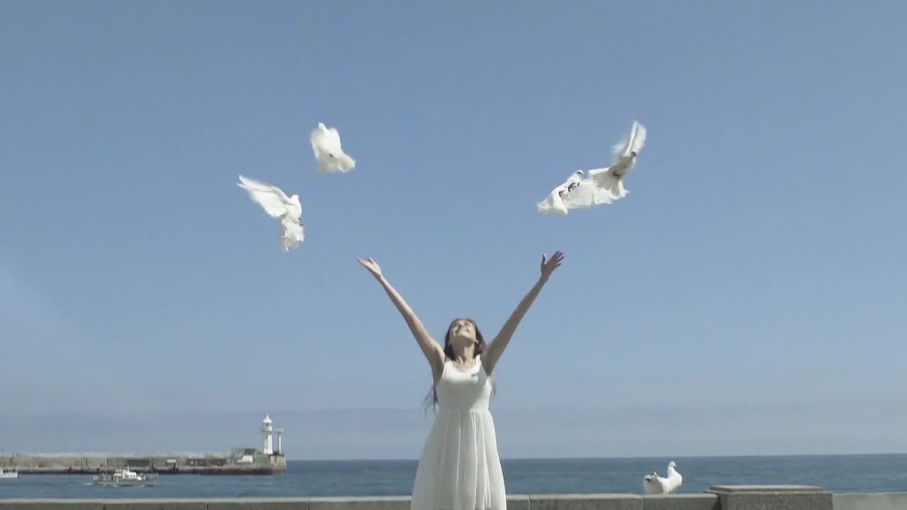 Happy Woman Releasing A Pigeons