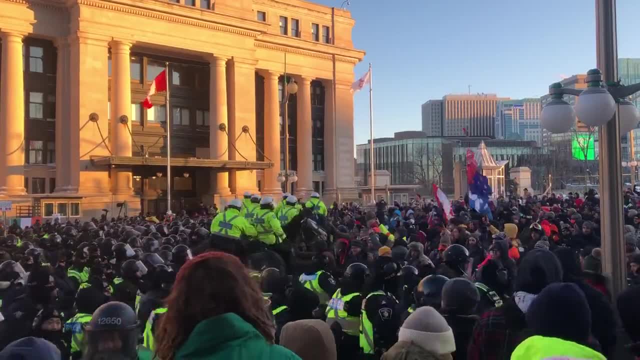 Chaotic scenes in Ottawa in front of the senate building. Police ride on horses into the crowd