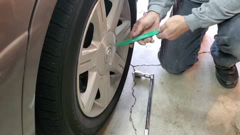 Checking the rotors and brake pads on a 2006 Cadillac