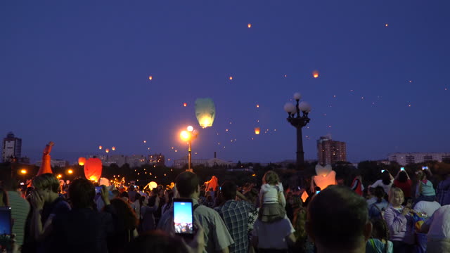 People Launching Air Lanterns At Night