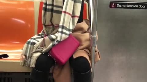 Woman raising arms up and down on subway train