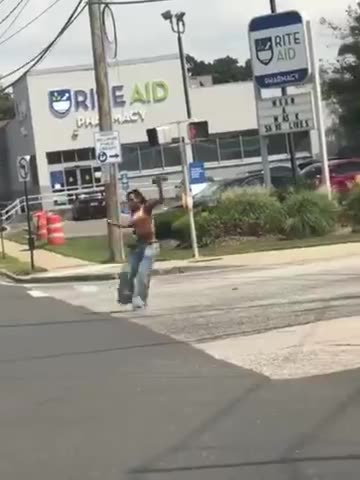 WOMAN WALKING AROUND THE STREETS OF NEW YORK POINTING A GUN AT EVERYONE GETS TAKEN OUT. GUESS WHO?