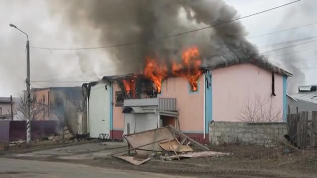 Houses burn after Russian bombing outside of Kyiv