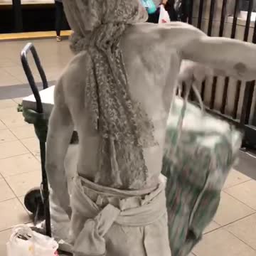 Man in all white grey paint on body