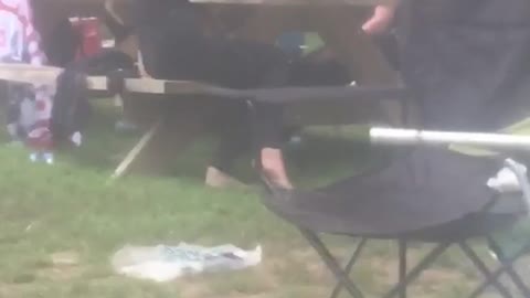 Sunglasses guy passed out at barbecue picnic table