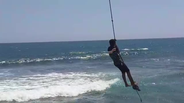 OMG ITS SWING TIME (Sri Lankan beach vibes) little boy swinging above the sea level