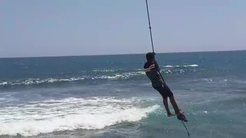 OMG ITS SWING TIME (Sri Lankan beach vibes) little boy swinging above the sea level