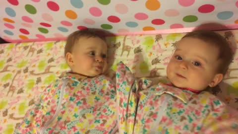 Baby girl steals pacifier from twin sister