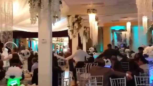 Music guy in grey dress shirt falls out of wedding dance line